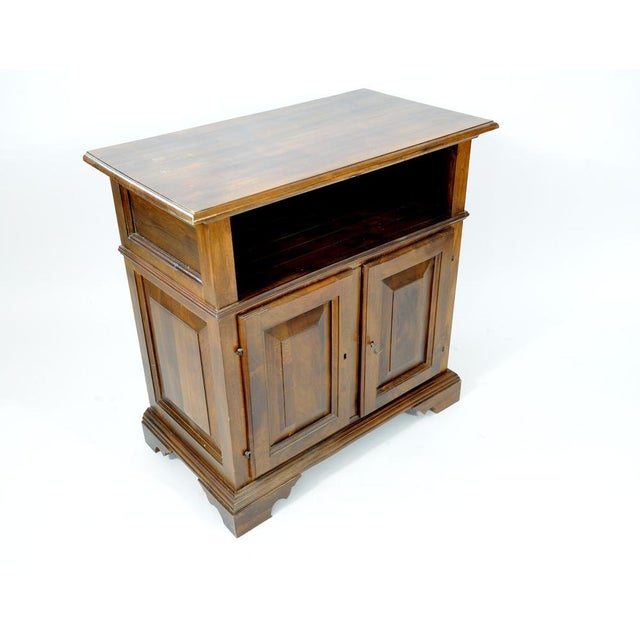 Small stylish sideboard, solid walnut, paneled doors and sides, one compartment under the top, shelf feet. Measures:...