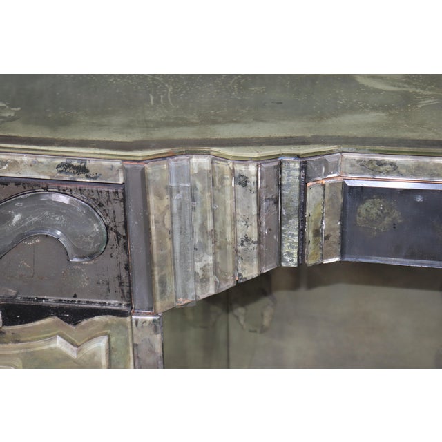 This extraordinary patinated and highly ornamented Hollywood Regency ladies’ vanity, attributed to Serge Roche, is an...