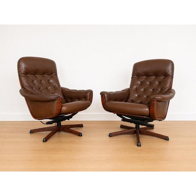 Vintage Swedish Mid-Century Brown Leather Swivel Chairs and footstools by Gote Møbler 1970s Crafted in Sweden in the 1970s...