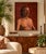 Striking vintage 1970s figurative portrait depicting a shirtless male subject rendered in oil on canvas. The artist uses...