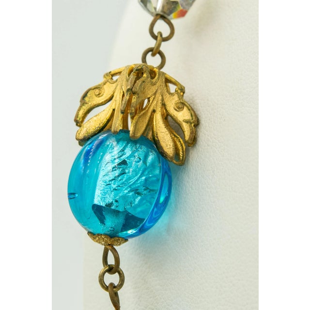 This necklace is gorgeous. I love the foil within the blue glass bead gives the piece such dimension and life. The draping...