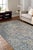 A hand-knotted wool rug in a traditional floral design, made in India and measuring 10' x 14'. Allover drawing held inside...