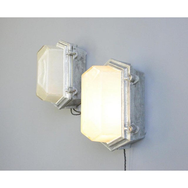 Industrial Bulkhead Lights By Maxlume Circa 1960s. Heavy cast steel casings - Prismatic glass with geometric design - The...