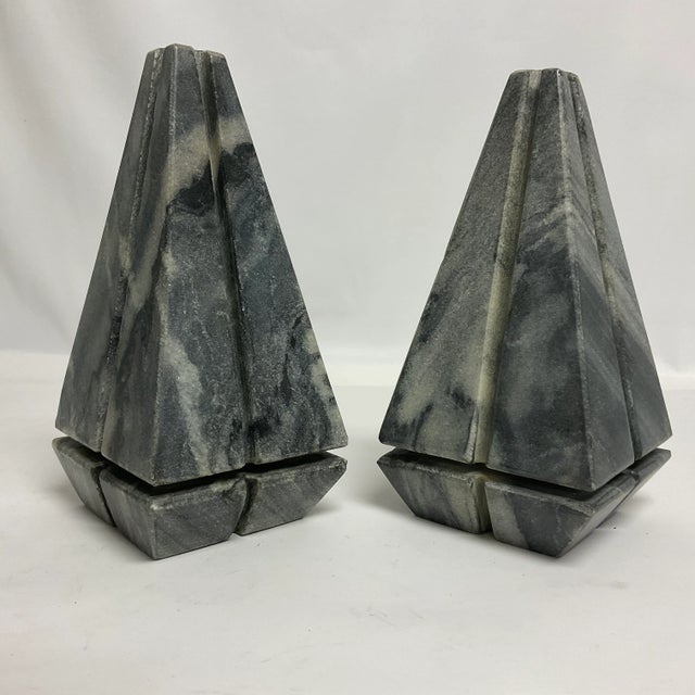 Offering a stunning pair of Italian Marble Pyramid Obelisks. The marble is tones of gray and ivory with various shades of...