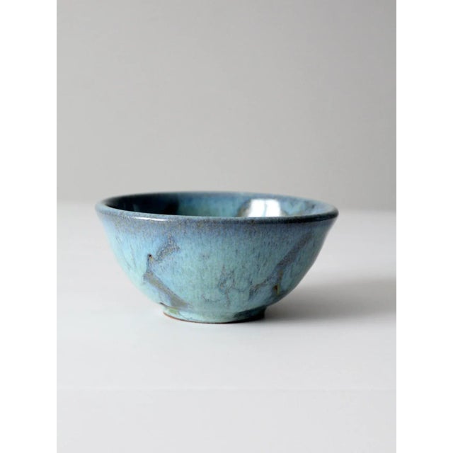 This is a vintage studio pottery bowl. The hand-crafted bowl has a stunning speckled blue glaze with abstract splashes of...