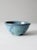 This is a vintage studio pottery bowl. The hand-crafted bowl has a stunning speckled blue glaze with abstract splashes of...