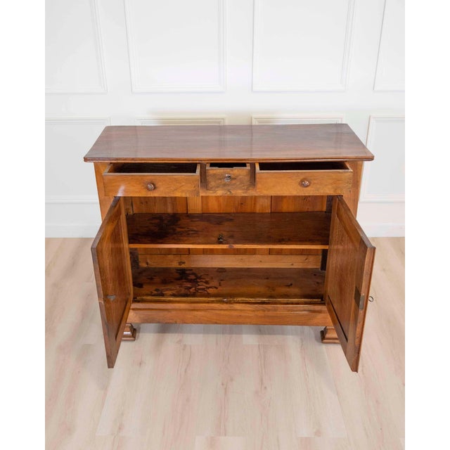 A handsome French 19th century Louis Philippe sideboard, beautifully crafted in richly grained walnut with the warm...