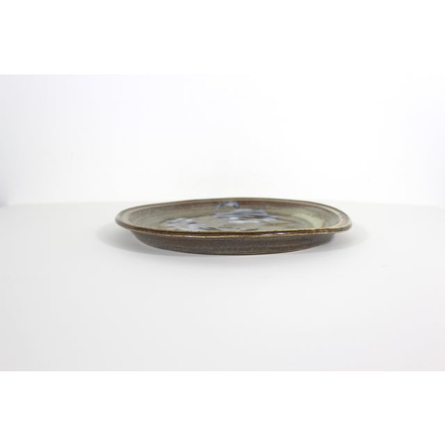 Vintage, handmade pottery plate. A bit Wabi Sabi - perfectly imperfect, as seen in the photos. The colours are browns and...