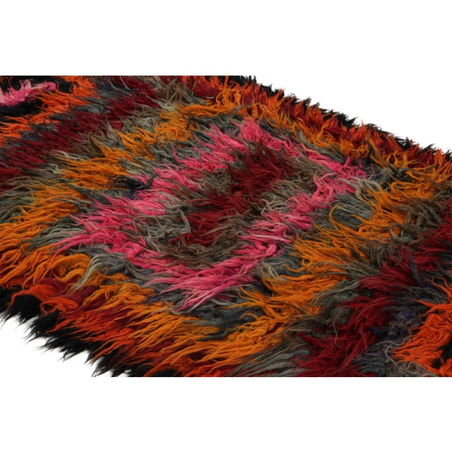 Hand-knotted in wool and originating from Turkey circa 1950-1960, this 4x12 vintage Tulu runner rug is an extremely rare...