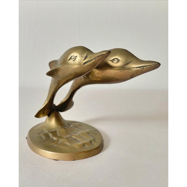 Who doesn’t love dolphins? A pair of mid-century brass dolphins leaping. Original patina, but could be polished. Charming...