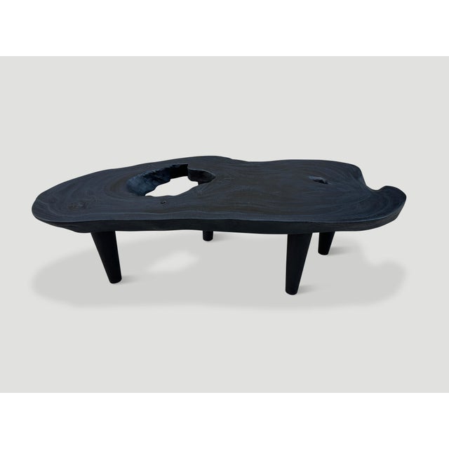 Sculptural, minimalist three inch thick single slab suar wood coffee table. Charred sanded and sealed revealing the...