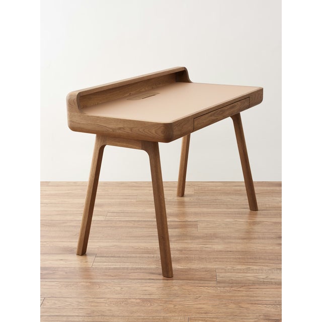 The FLOW is a writing desk built for a calm, focused workspace – clean lines, solid oak, and a natural linoleum (leather...
