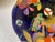 Designed by Molly Hancock multicolored floral and abstract designs on cobalt blue