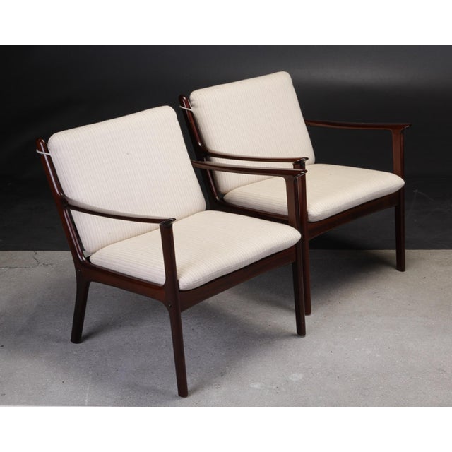 Set of two Ole Wanscher PJ112 mahogany lounge chairs produced by P. Jeppesens Møbelfabrik. Frames and upholstery of the...