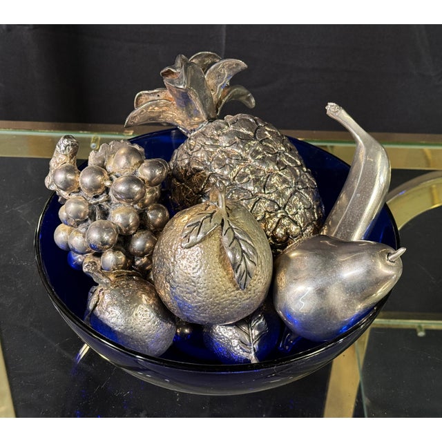 This assembled collection of seven silverplated decorative fruit sculptures makes a strong still life grouping for a...