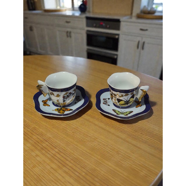 The Formalities pair by Baum Brothers Porcelain Butterflies Demi-Tasse Cup & Saucer set is a vintage and elegant addition...