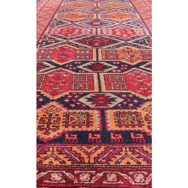 This antique Persian Karajeh gallery rug features an all-over sub-geometric design rendered in multicolor tones, set upon...