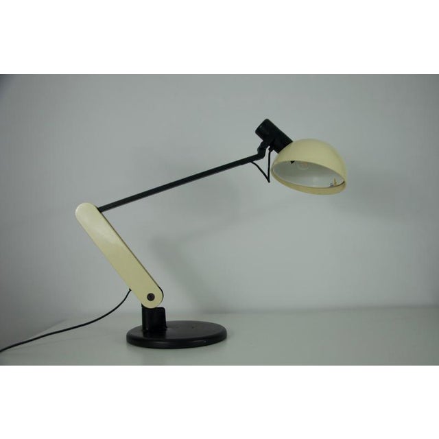This is the iconic “praxi” table lamp designed by bruno gecchelin for iguzzini, italy, in 1982. A hallmark of 1980s...