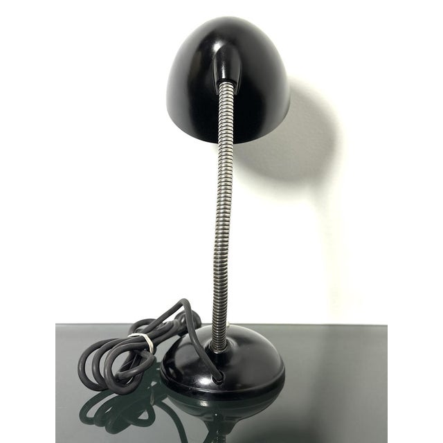 An icon of modernist design, this table lamp designed by Eric Kirkman Cole combines the elegance of black Bakelite with...