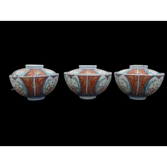 Set of 3 gorgeous Japanese Imari, Meiji era porcelain soup cups or bowls with lids, each featuring gorgeous floral and...