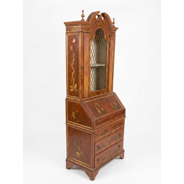 This Venetian-style secretary bookcase features a rich, hand-painted red lacquer finish embellished with detailed gilded...