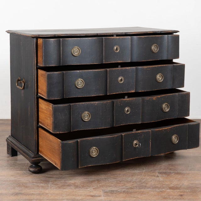 This rococo large chest of four drawers features a serpentine front and is raised on large bun feet. Restored, later...