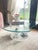 A striking sculptural coffee table featuring an organic free-form silhouette and low-profile design. Crafted from clear...