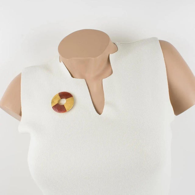 This stunning Yves Saint Laurent Paris signed brooch features a dimensional donut shape with textured gilt metal in a...