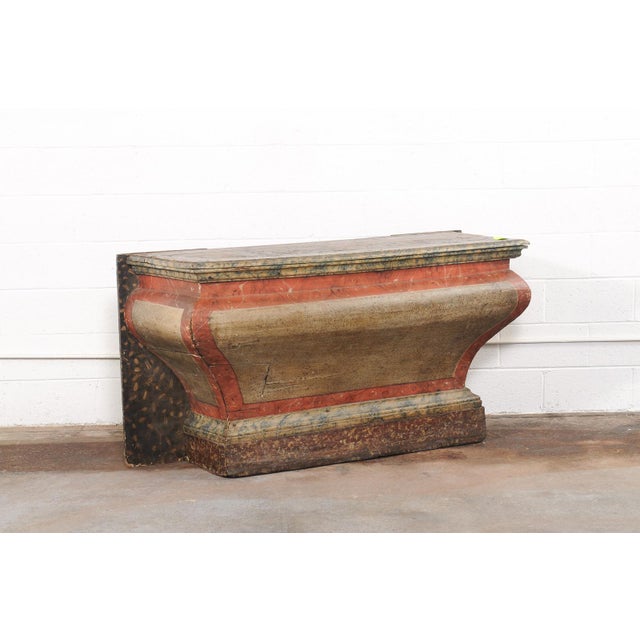 A Brazilian sculptural wooden console table, which retains its remarkable original painted finish, from the 18th century....
