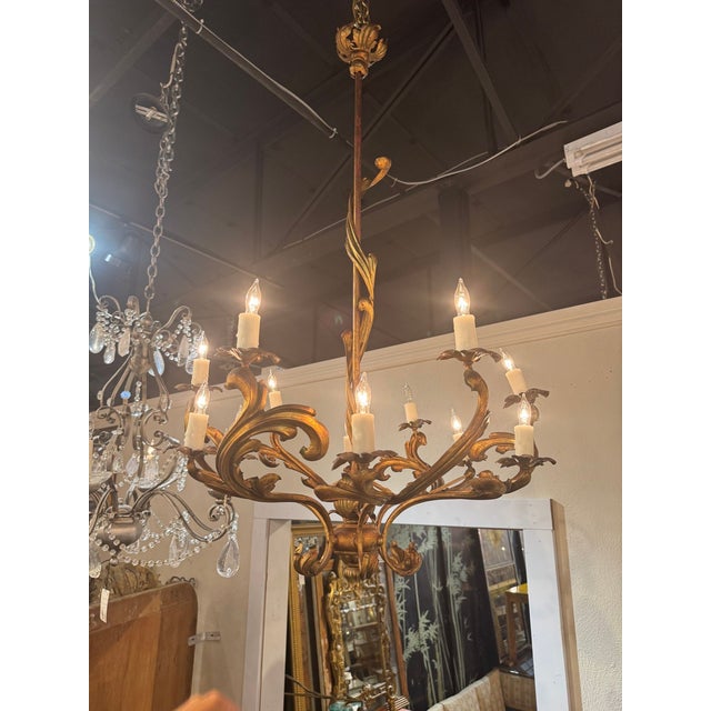 The Italian Rococo Gilt Iron Chandeliers are elegant and ornate lighting fixtures designed to add sophistication and style...