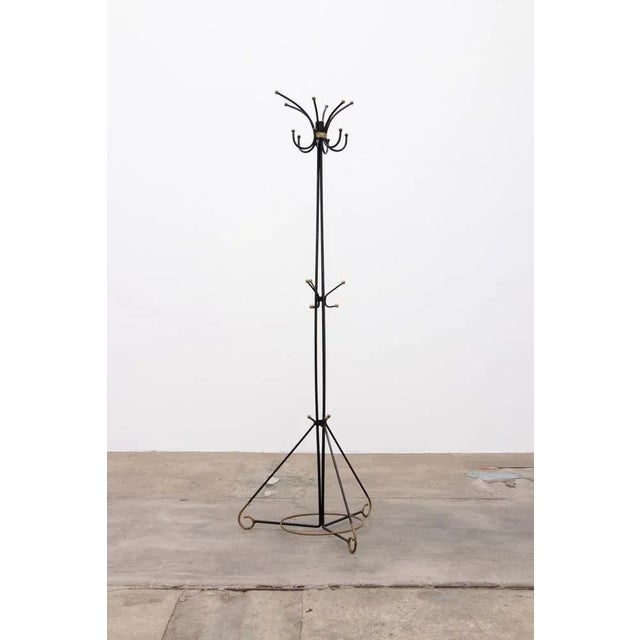 French Hand-forged iron coat rack, 1960s-50s. Beautiful slim black iron coat rack with gold-colored copper knobs, the top...