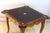 A carved and molded wooden games table, the frieze with four drawers and four token holders, the cabriole legs topped with...