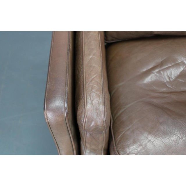 This elegant three-seat mid-century modern sofa was produced in Denmark in the 1970s and exemplifies the restrained...