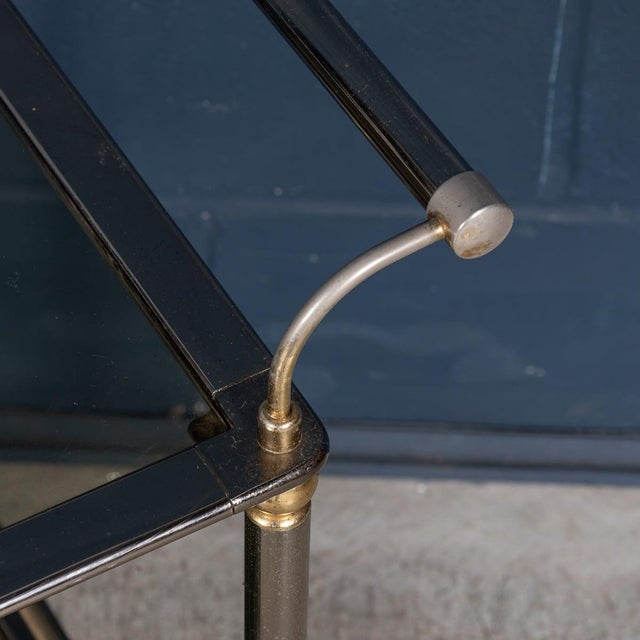 This 20th Century drinks trolley boasts a brushed steel and brass frame, exemplifying the elegance of contemporary Italian...