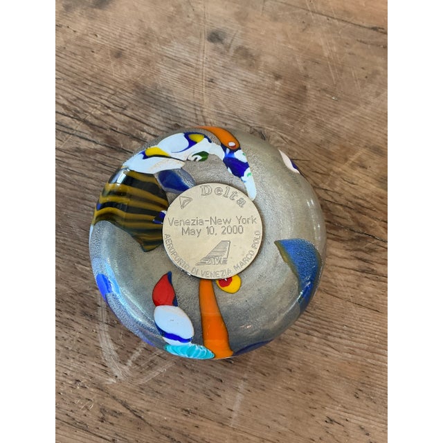 A stunning example of Venetian glass artistry, this vintage Murano glass paperweight is a captivating display of color and...