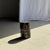 Small side table in black petrified wood with beige streaks. Petrified wood is a fossilized wood (from the same family as...