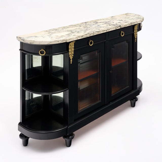 An exceptionally elegant French Louis XVI style buffet vitrine, circa 1880, crafted in mahogany and finished in a rich...
