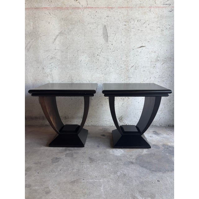A compelling pair of late 20th century Art Deco side tables by Jimeco, crafted in Colombia from richly grained solid...