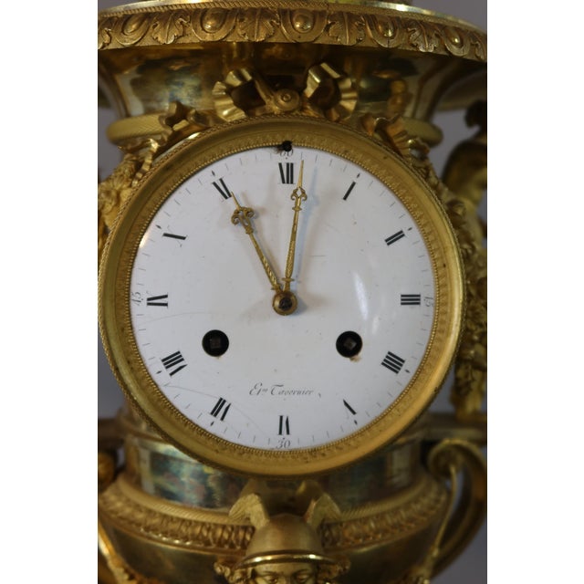 A rare Medici-style clock and pair of vases in finely chased and matte gilt bronze and griotte red marble. The clock has a...