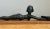 This vintage Egyptian-inspired metal figure is mounted on a rectangular wooden base and presents a stylized, elongated...