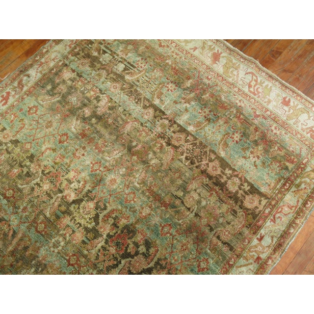 Stunning Persian Malayer rug from the early 20th century with a green field color, accents in terracotta, pink and brown....