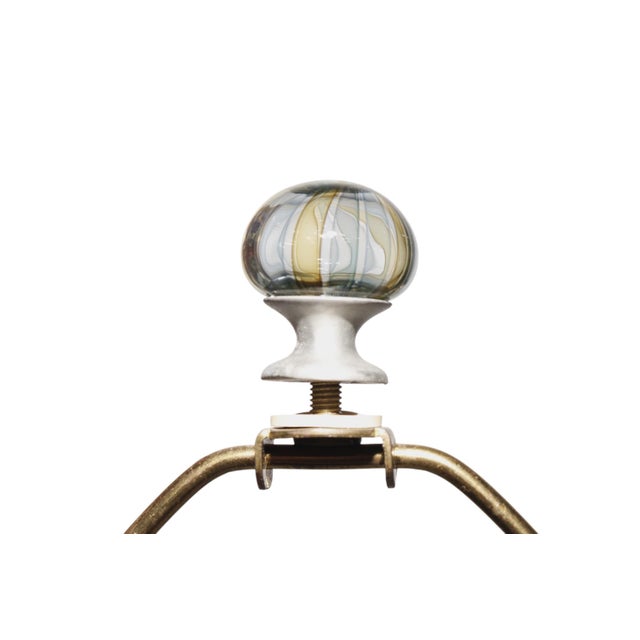 A pair of tan, blue and green filigrana and relief blown glass table lamps attributed to Alfredo Barbini. Glass columns...