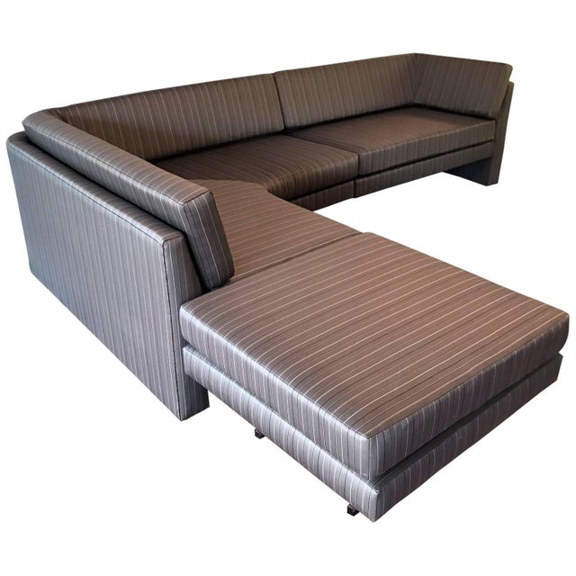 The sectional sofa with Lucite supporting legs features three units, a right arm section, a middle corner return and an...