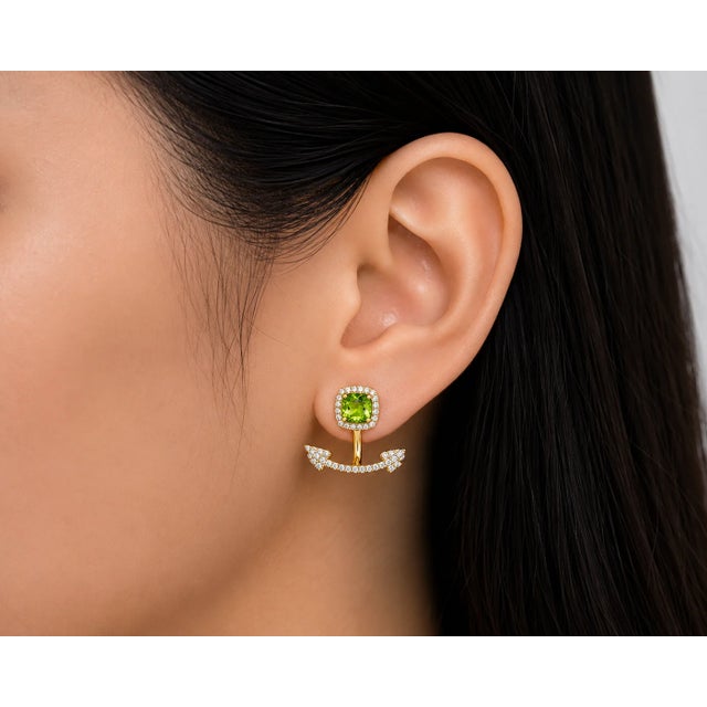14K yellow gold earrings featuring natural peridots totaling 1.2 carats, accented with brilliant round diamonds totaling...