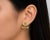 14K yellow gold earrings featuring natural peridots totaling 1.2 carats, accented with brilliant round diamonds totaling...