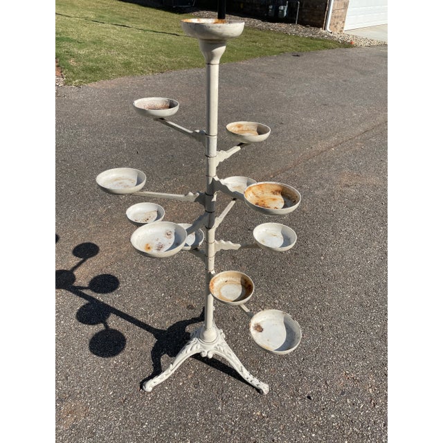 Victorian (1900's) cast iron tiered plant stand. Nine arms with twelve display plates and an ornate tripod base. Heavy and...
