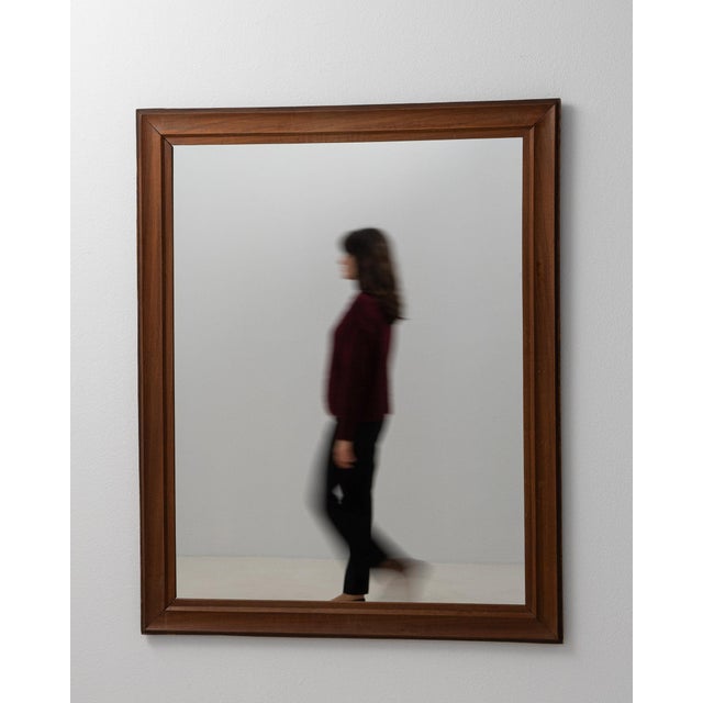 A mirror whose medium brown wood frame, rectangular gives it real character at first glance. It was made in France during...