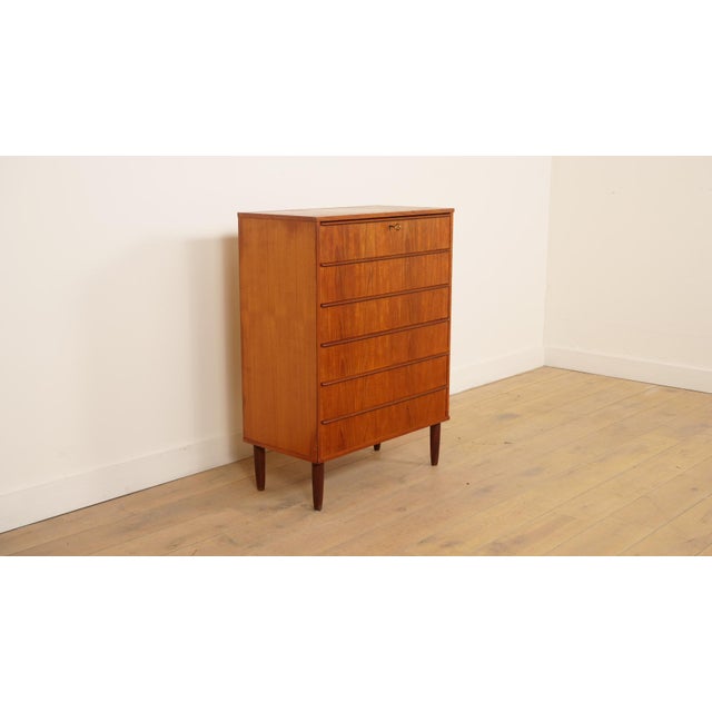 Beautiful vintage Danish chest of drawers from the 1960s, crafted from warm wood with a lovely, vibrant grain. The cabinet...