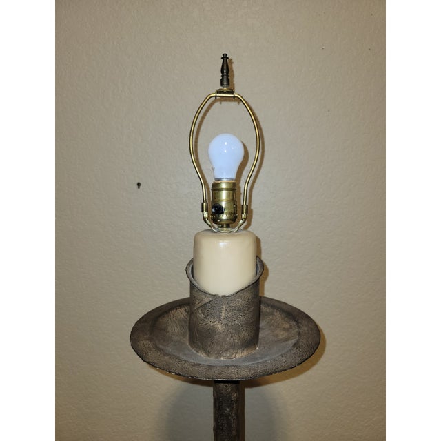 A very unusual cast iron floor lamp with a near-pristine surface showing a textured surface resembling bark with...