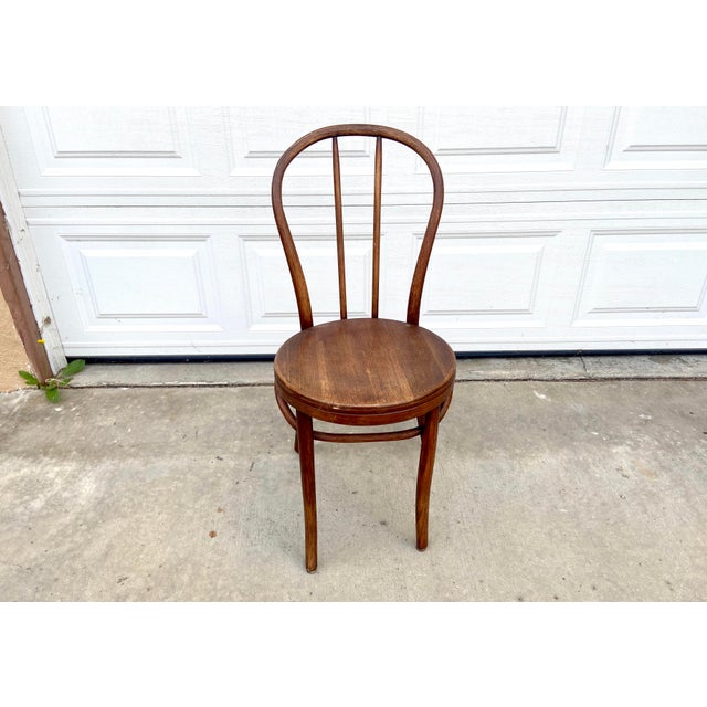 A piece of living history, this handcrafted bentwood side chair embodies the elegance of the great European café era....